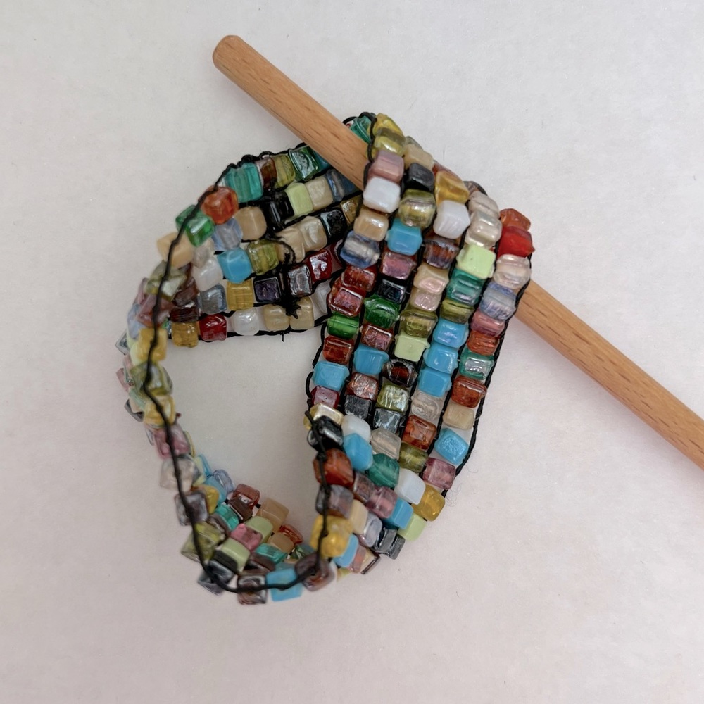 Bracelet, multi-colored trade beads on stretching string
